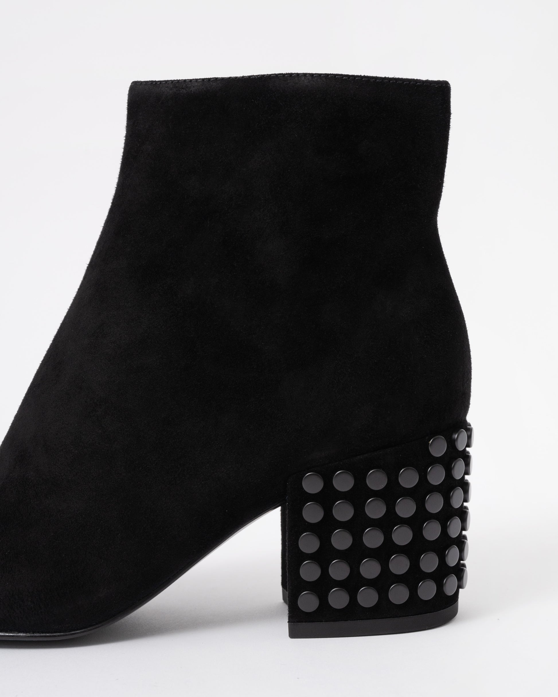 Black suede ankle boot with studded details on a white background