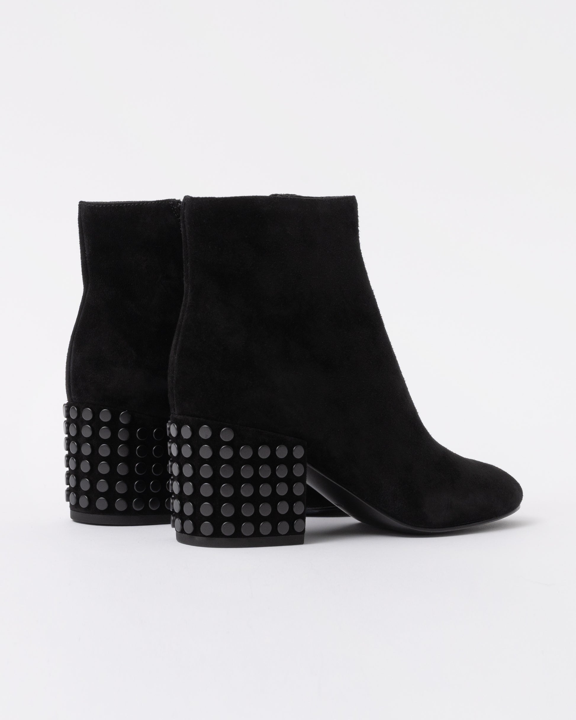 Black suede ankle boots with studded details on a white background