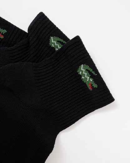 Black ribbed knit socks with green crocodile logos and small red accents on the cuffs, shown on a plain white background.