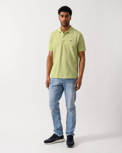 full length shot of a model wearing a Lacoste Classic Fit L.12.12 Mens Short Sleeve Polo Shirt in Birch UYB