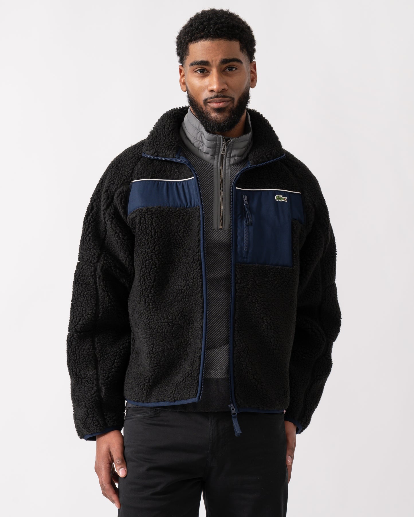 model wearing a Lacoste Colorblock Fleece Mens Zipped Jacket in Black and Navy Blue