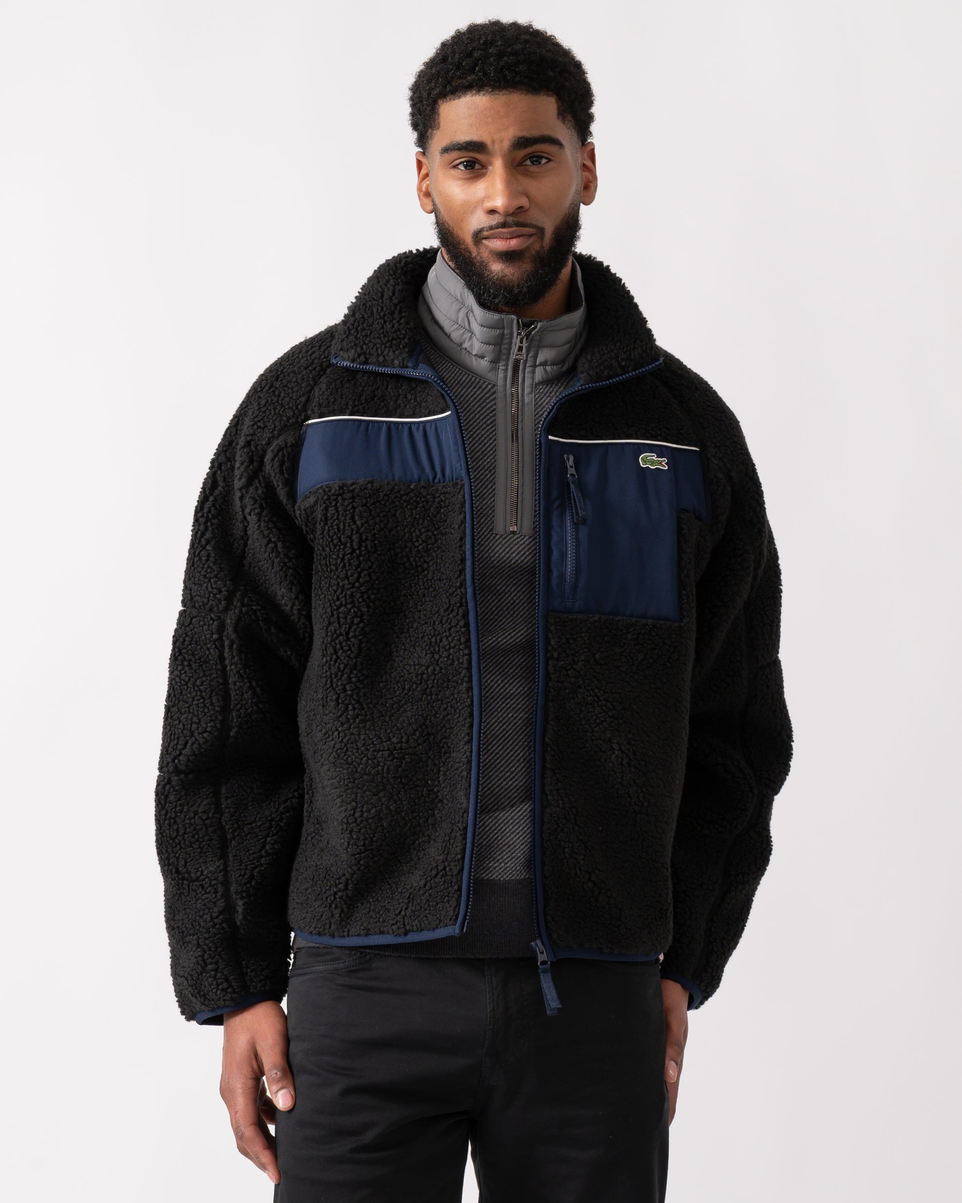 model wearing a Lacoste Colorblock Fleece Mens Zipped Jacket in Black and Navy Blue