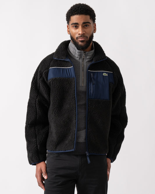 model wearing a Lacoste Colorblock Fleece Mens Zipped Jacket in Black and Navy Blue