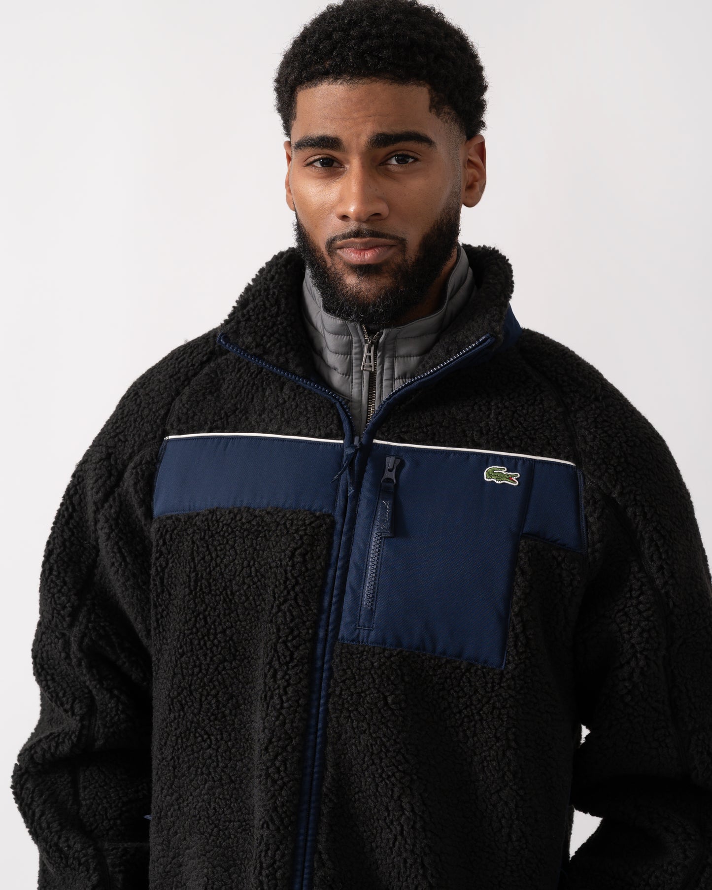 detail shot of a model wearing a Lacoste Colorblock Fleece Mens Zipped Jacket in Black and Navy Blue
