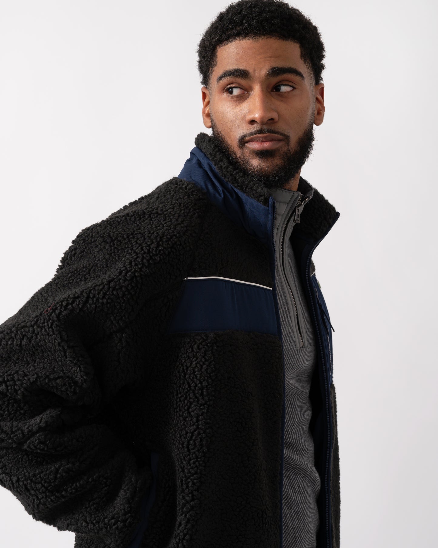 side shot of a model wearing a Lacoste Colorblock Fleece Mens Zipped Jacket in Black and Navy Blue
