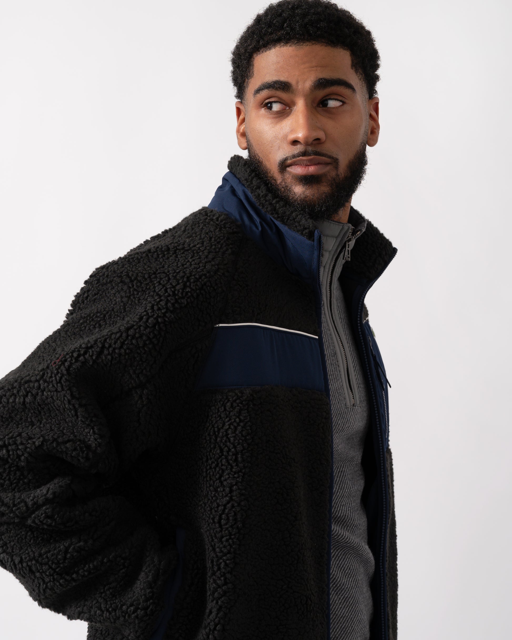 side shot of a model wearing a Lacoste Colorblock Fleece Mens Zipped Jacket in Black and Navy Blue