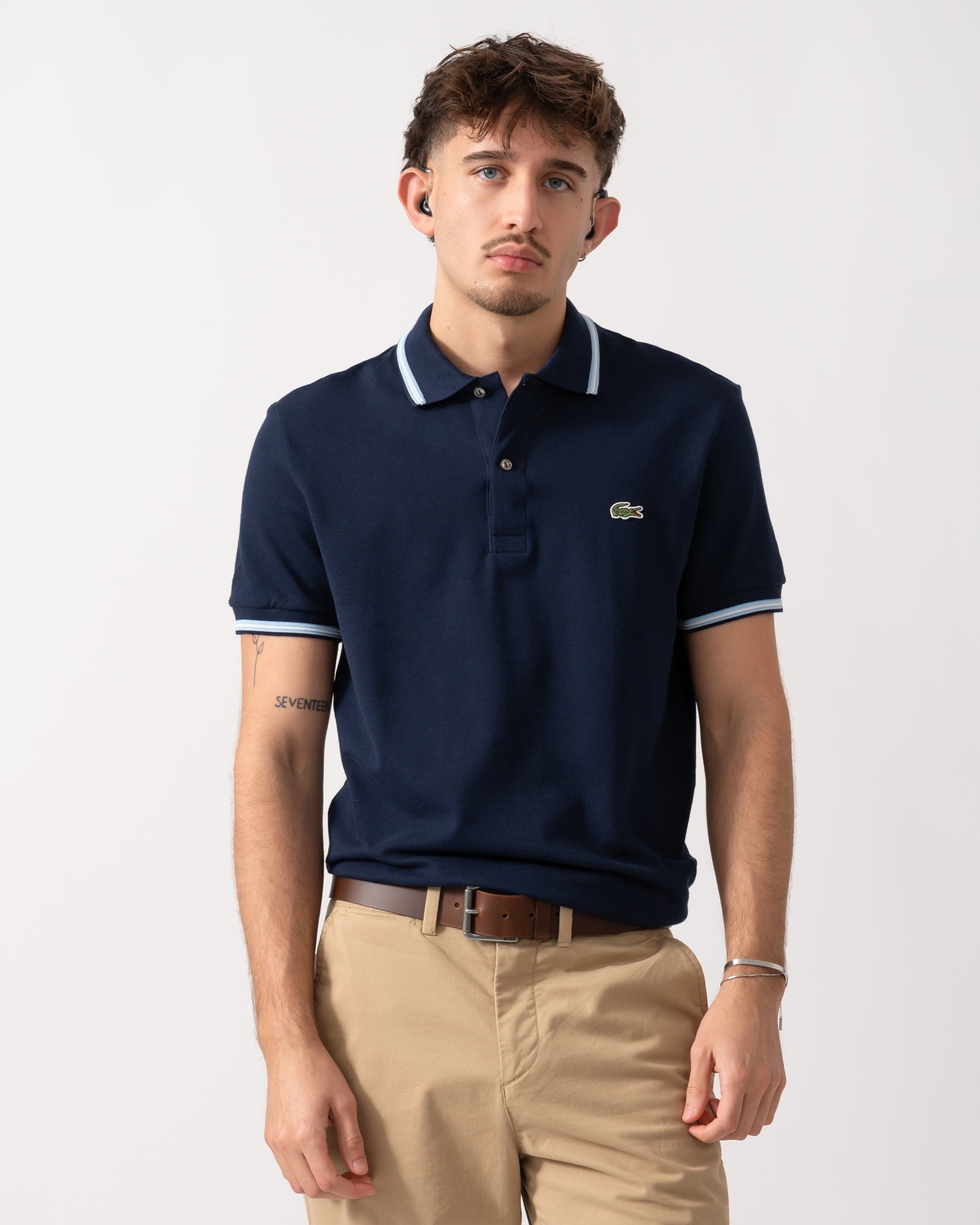 Model wearing a Lacoste Contrast Collar Pique Mens Regular Fit Polo Shirt in Navy Blue