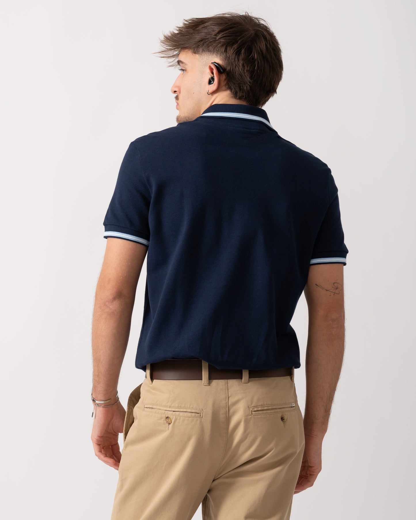 Back shot of a Model wearing a Lacoste Contrast Collar Pique Mens Regular Fit Polo Shirt in Navy Blue