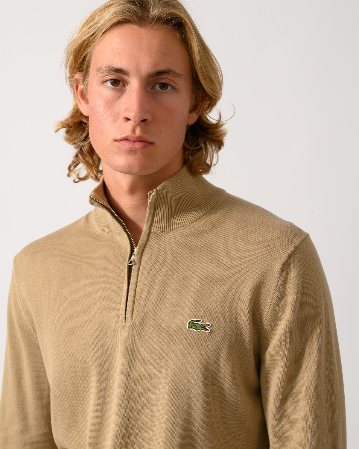 close up of model wearing a Lacoste Half Zip Logo Mens Sweatshirt in Cookie SIX