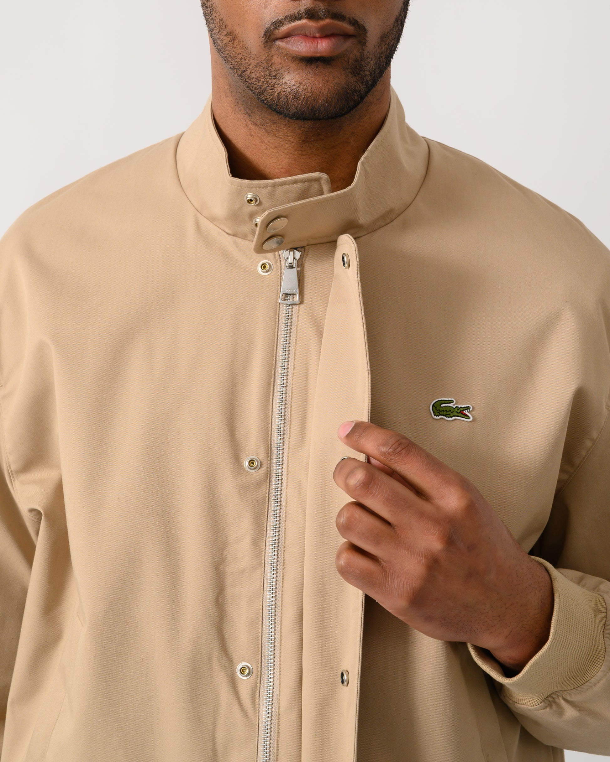 zip detail shot of a Lacoste Lightweight Water-Repellent Twill Mens Harrington Jacket in Viennese 02S