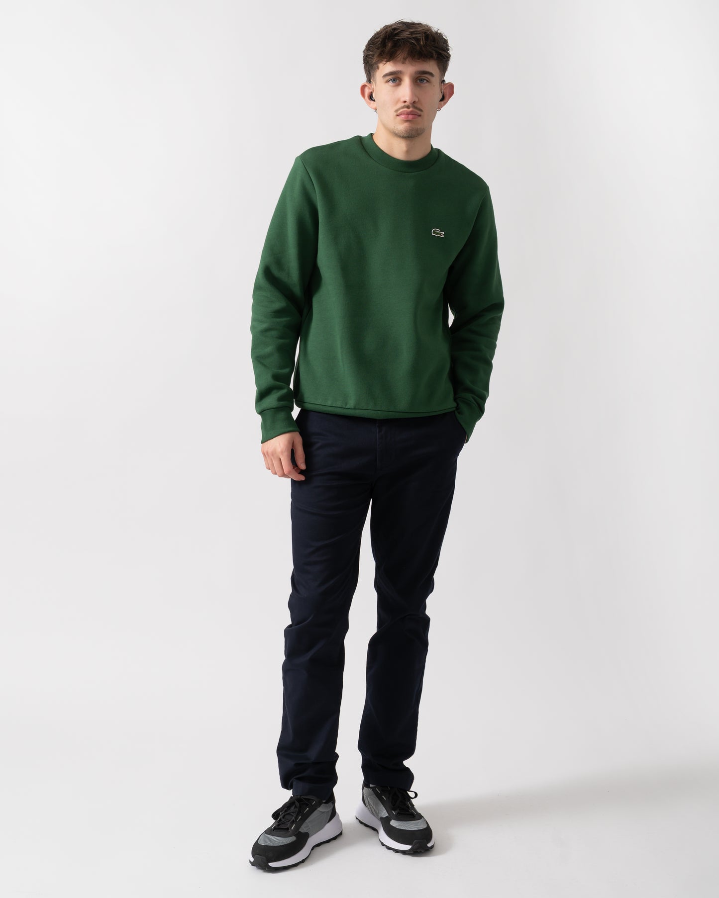 full length shot of a model wearing a Lacoste Mens Crew Neck Fleece Sweatshirt in Green 132