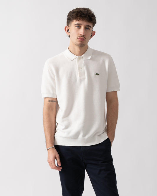 Studio shot of a model wearing a Lacoste Moss Stitch Cotton Polo Collar Mens Sweater in Flour 70V