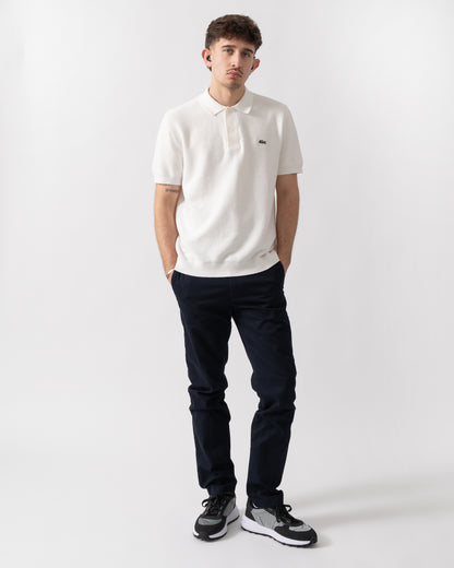 full length shot of a model wearing a Lacoste Moss Stitch Cotton Polo Collar Mens Sweater in Flour 70V