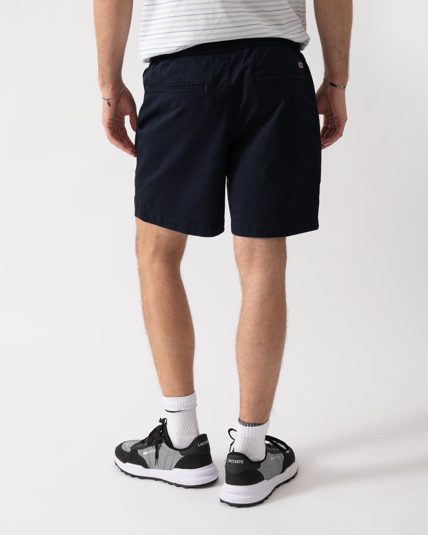 back shot of a model wearing Lacoste Relaxed Fit Mens Stretch Cotton Shorts in Abysm HDE