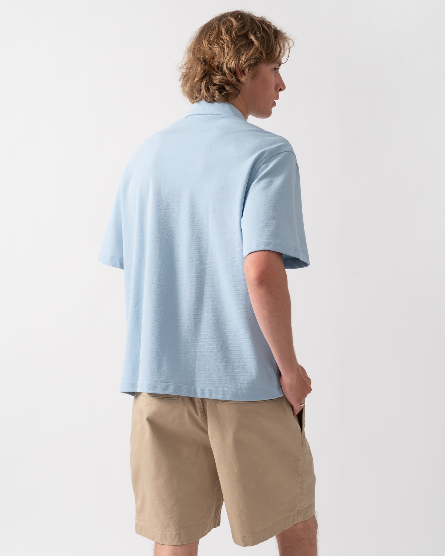 back of a model wearing a Lacoste Relaxed Fit Short Sleeved Mens Piqué Shirt in Chambray HBA