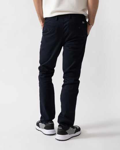 back shot of a model wearing Lacoste Slim Fit Stretch Cotton Mens Chinos in Abysm HDE