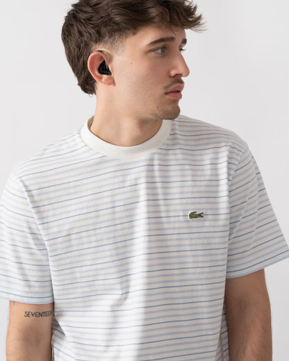 close up shot of a model wearing Lacoste Stripe Mens Classic Fit T-Shirt in Phoenix Blue-Flour