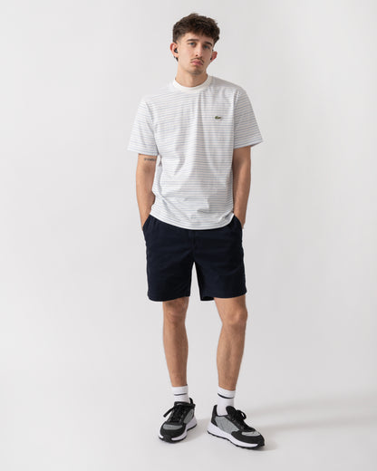 full length shot of a model wearing Lacoste Stripe Mens Classic Fit T-Shirt in Phoenix Blue-Flour