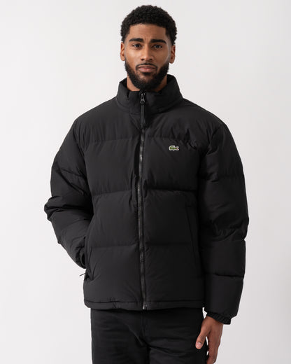 model wearing a Lacoste Water-Repellent Packable Hood Mens Down Jacket in Black