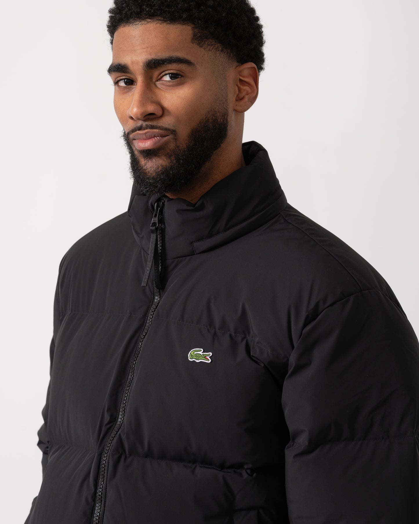 detail shot of a model wearing a Lacoste Water-Repellent Packable Hood Mens Down Jacket in Black