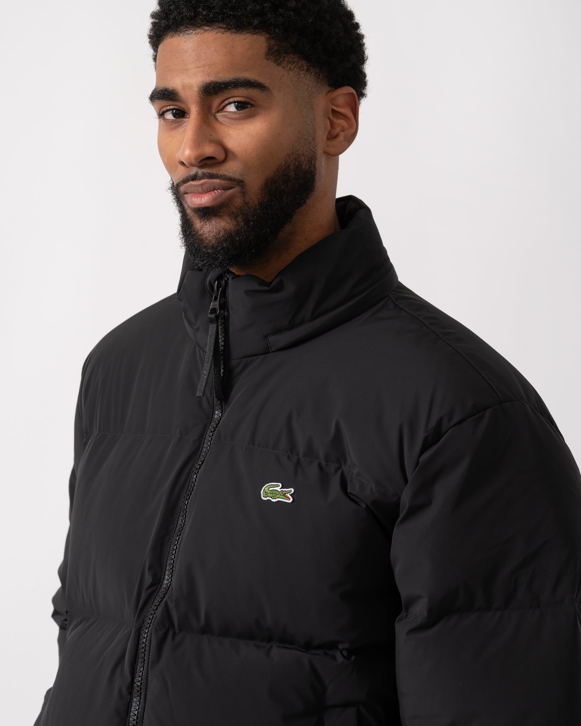 detail shot of a model wearing a Lacoste Water-Repellent Packable Hood Mens Down Jacket in Black