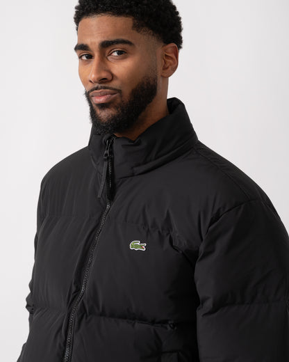 detail shot of a model wearing a Lacoste Water-Repellent Packable Hood Mens Down Jacket in Black