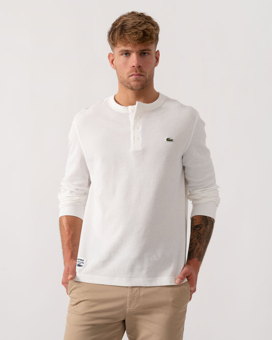 Model wearing Lacoste Boxy Tunisian Neck Knit T-Shirt in Flour 70V - Main