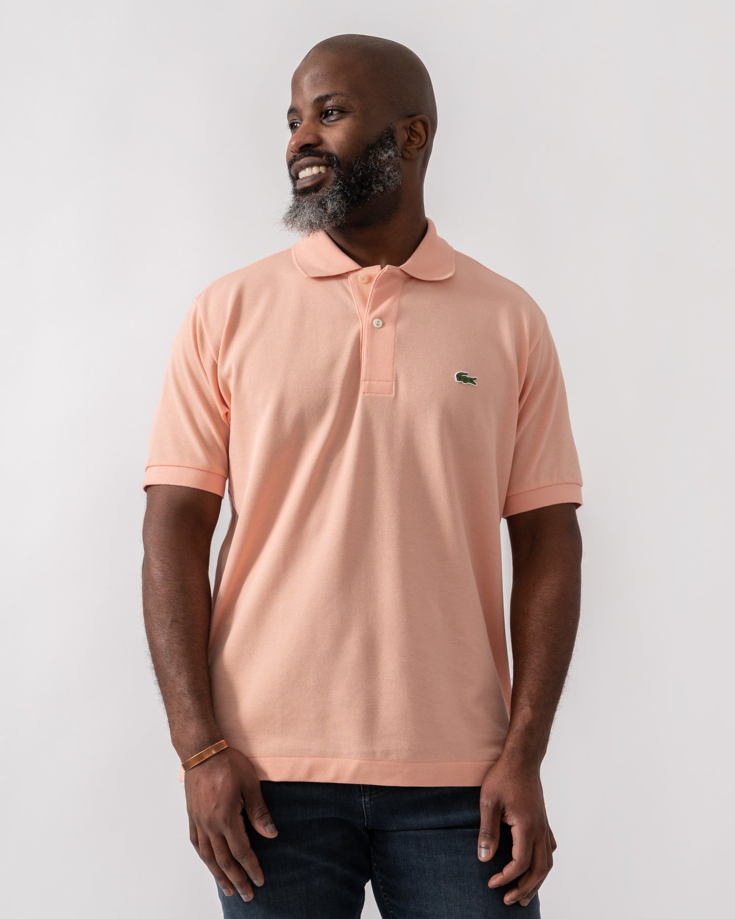Model wearing Lacoste Classic Fit L.12.12 Mens Short Sleeve Polo Shirt in Miami UI2 - Mid Shot