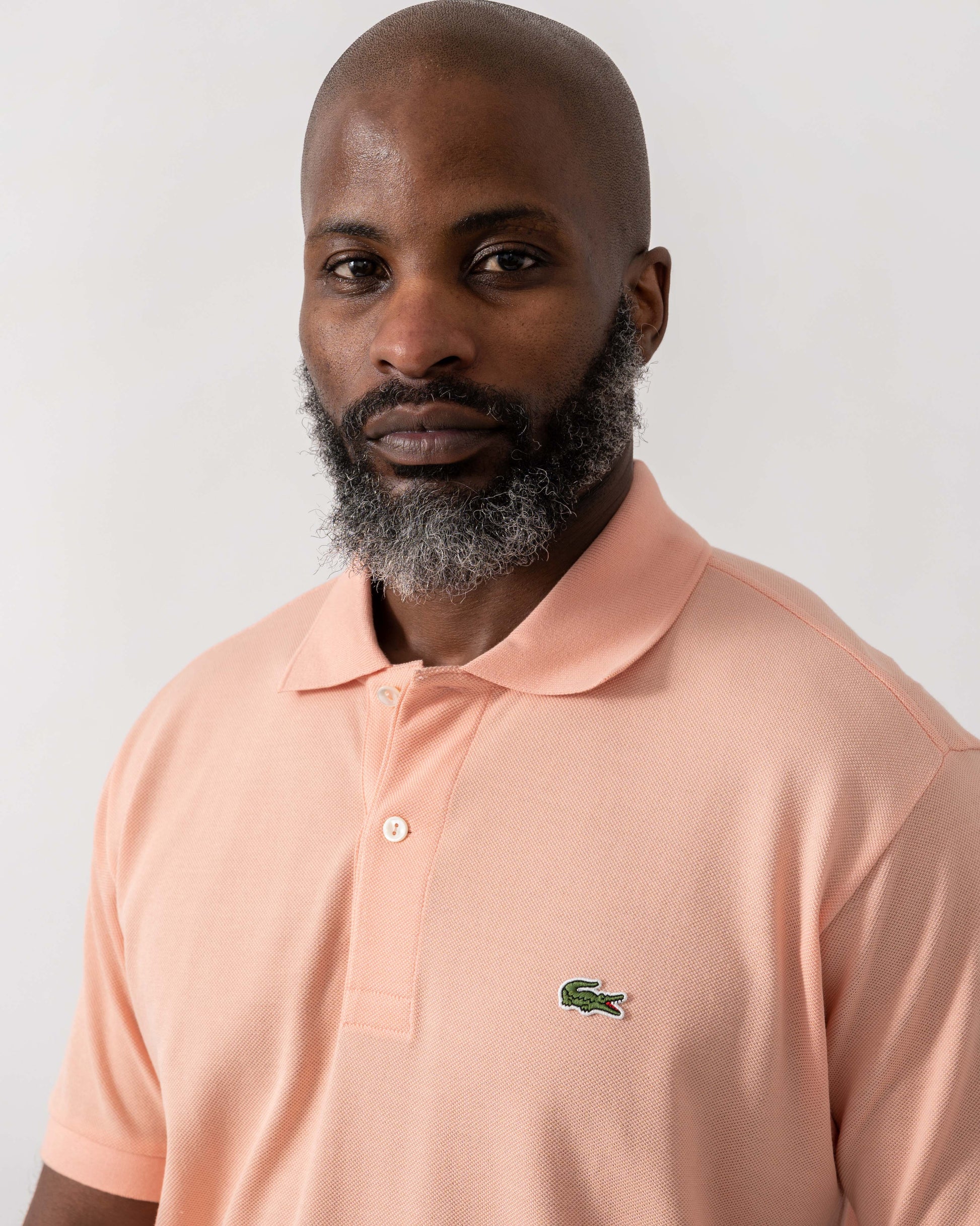 Model wearing Lacoste Classic Fit L.12.12 Mens Short Sleeve Polo Shirt in Miami UI2 - Detail