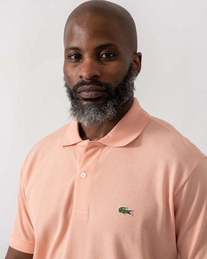 Model wearing Lacoste Classic Fit L.12.12 Mens Short Sleeve Polo Shirt in Miami UI2 - Detail