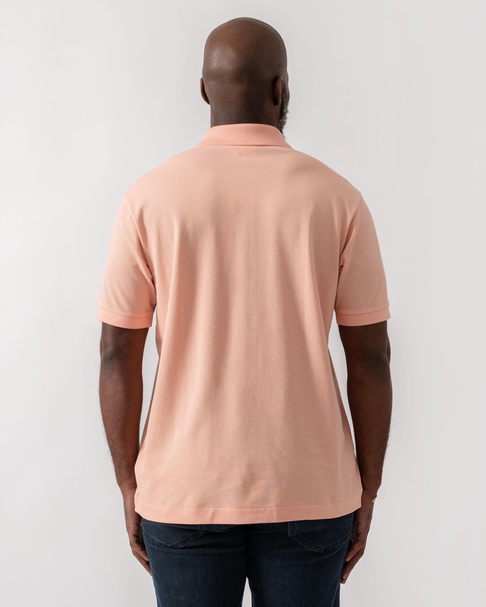 Model wearing Lacoste Classic Fit L.12.12 Mens Short Sleeve Polo Shirt in Miami UI2 - Back