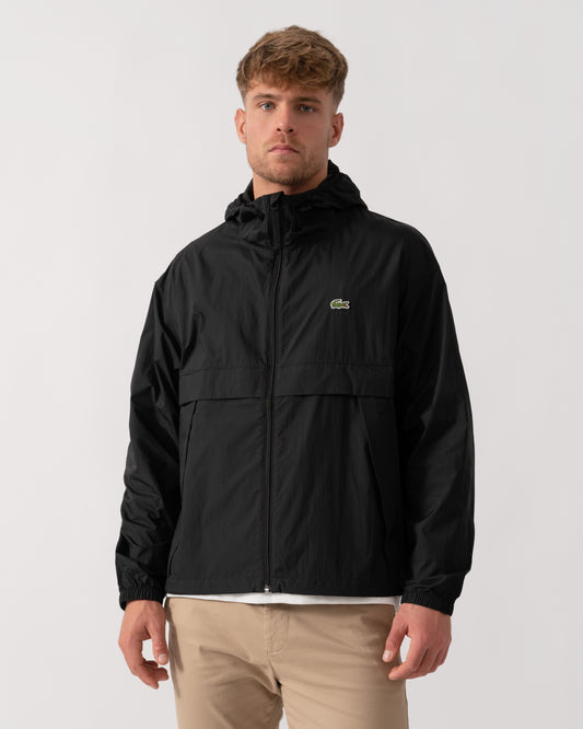 Model wearing Lacoste Lightweight Packable Water-Repellent Ripstop Jacket in Black 031 - Main
