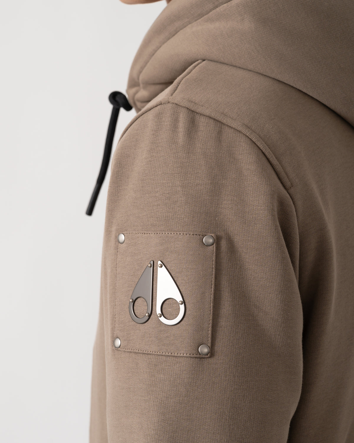 logo detail of a Moose Knuckles Classic Bunny 3 Mens Fleece Hoodie in Ashen 2019
