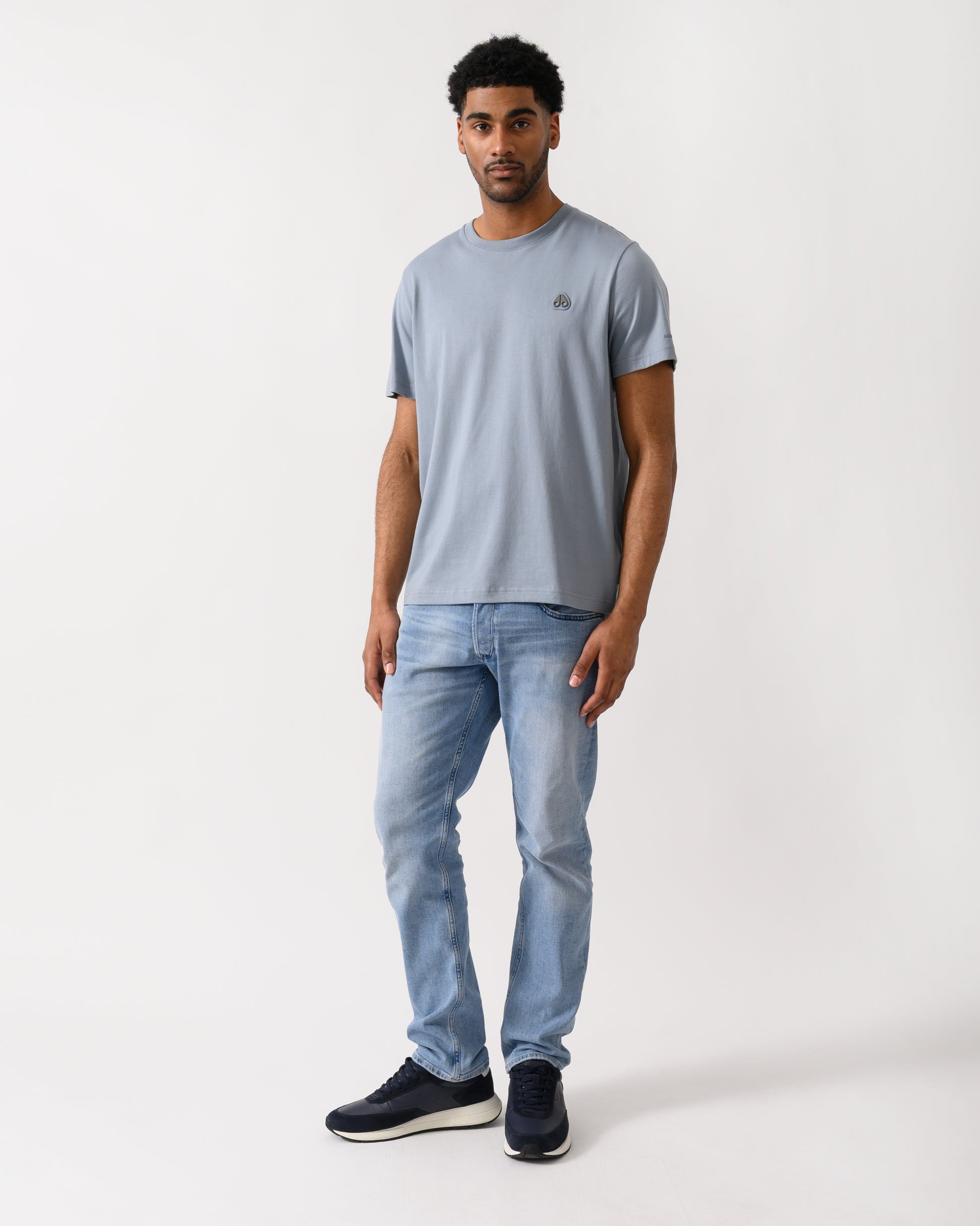 full length shot of a model wearing a Moose Knuckles Crescent Mens T-Shirt in Jet Stream 1884