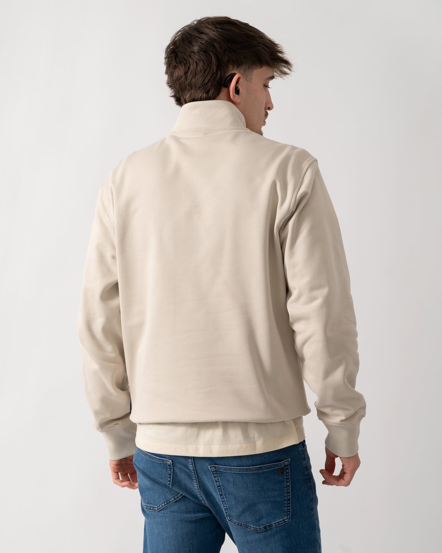 back shot of a model wearing a Moose Knuckles Hartsfield Mens 1/4 Zip Sweatshirt in Alabaster 1705