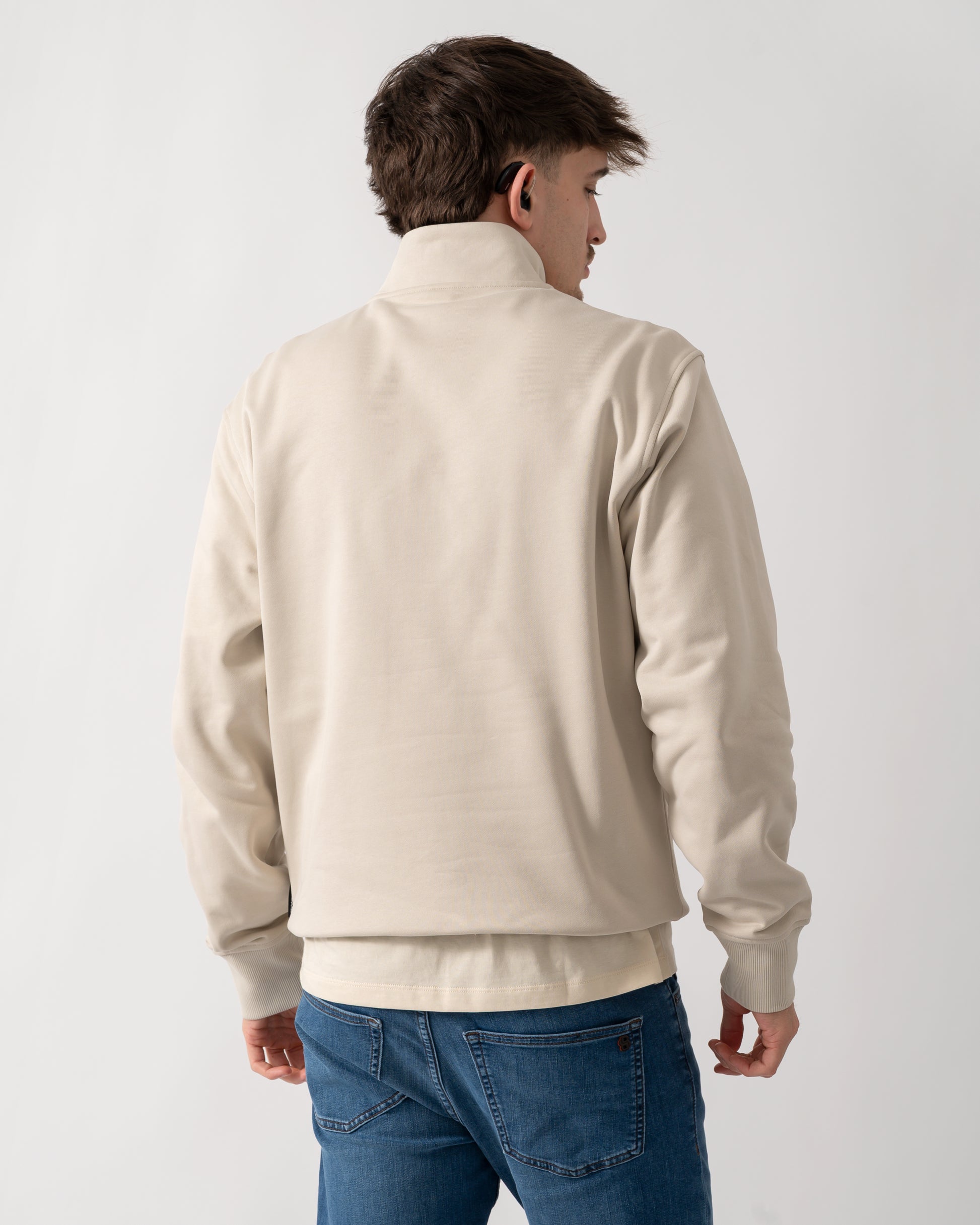 back shot of a model wearing a Moose Knuckles Hartsfield Mens 1/4 Zip Sweatshirt in Alabaster 1705