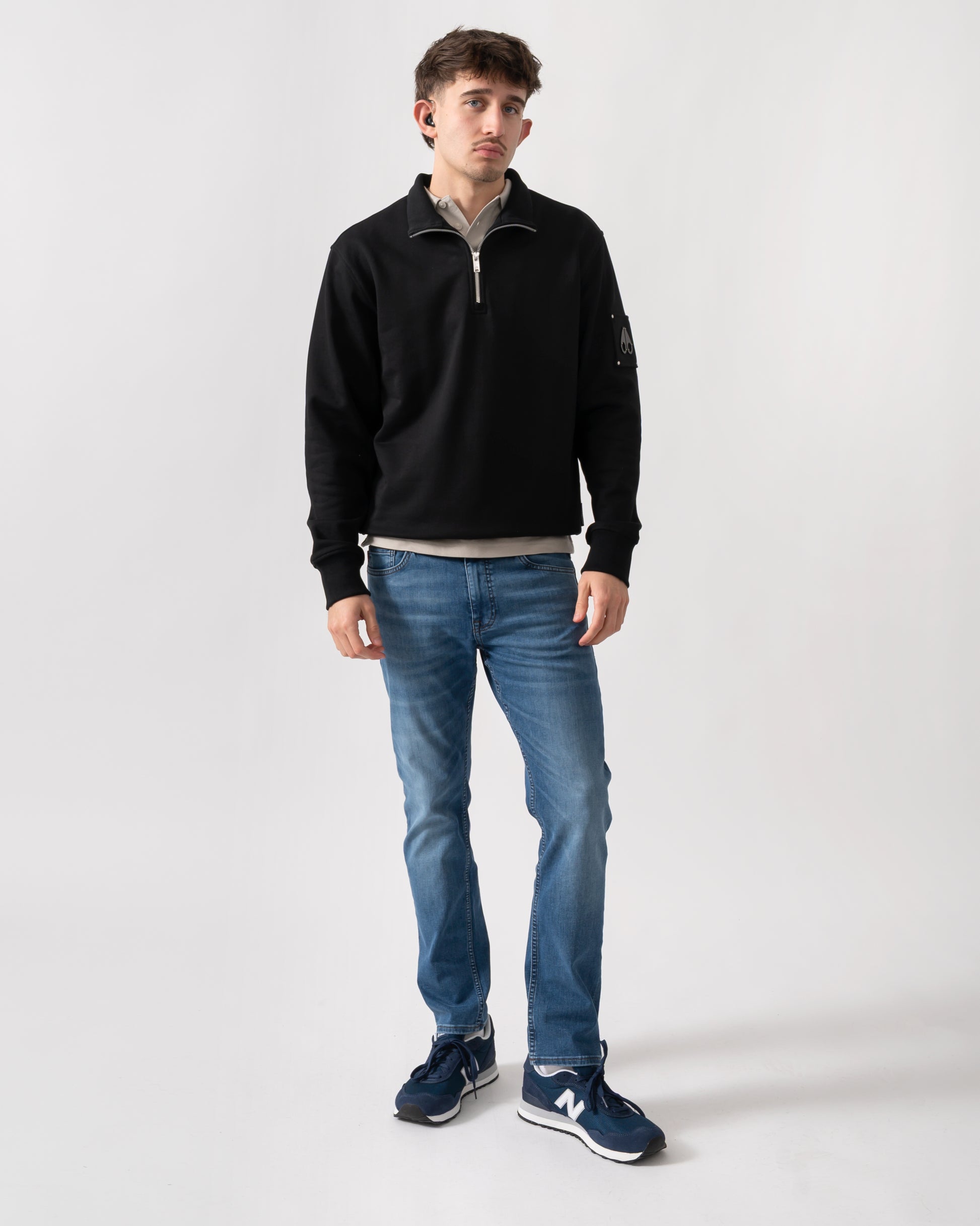 full length shot of a model wearing a Moose Knuckles Hartsfield Mens quarter Zip Sweatshirt in Black 292
