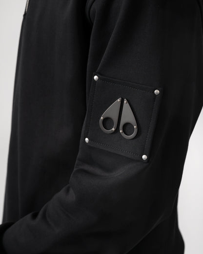 logo detail shot of a Moose Knuckles Hartsfield Mens quarter Zip Sweatshirt in Black 292