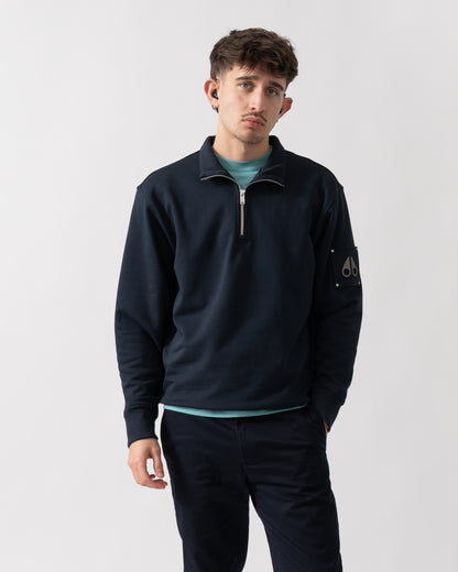 studio shot of a model wearing a Moose Knuckles Hartsfield Mens quarter Zip Sweatshirt in Navy 833