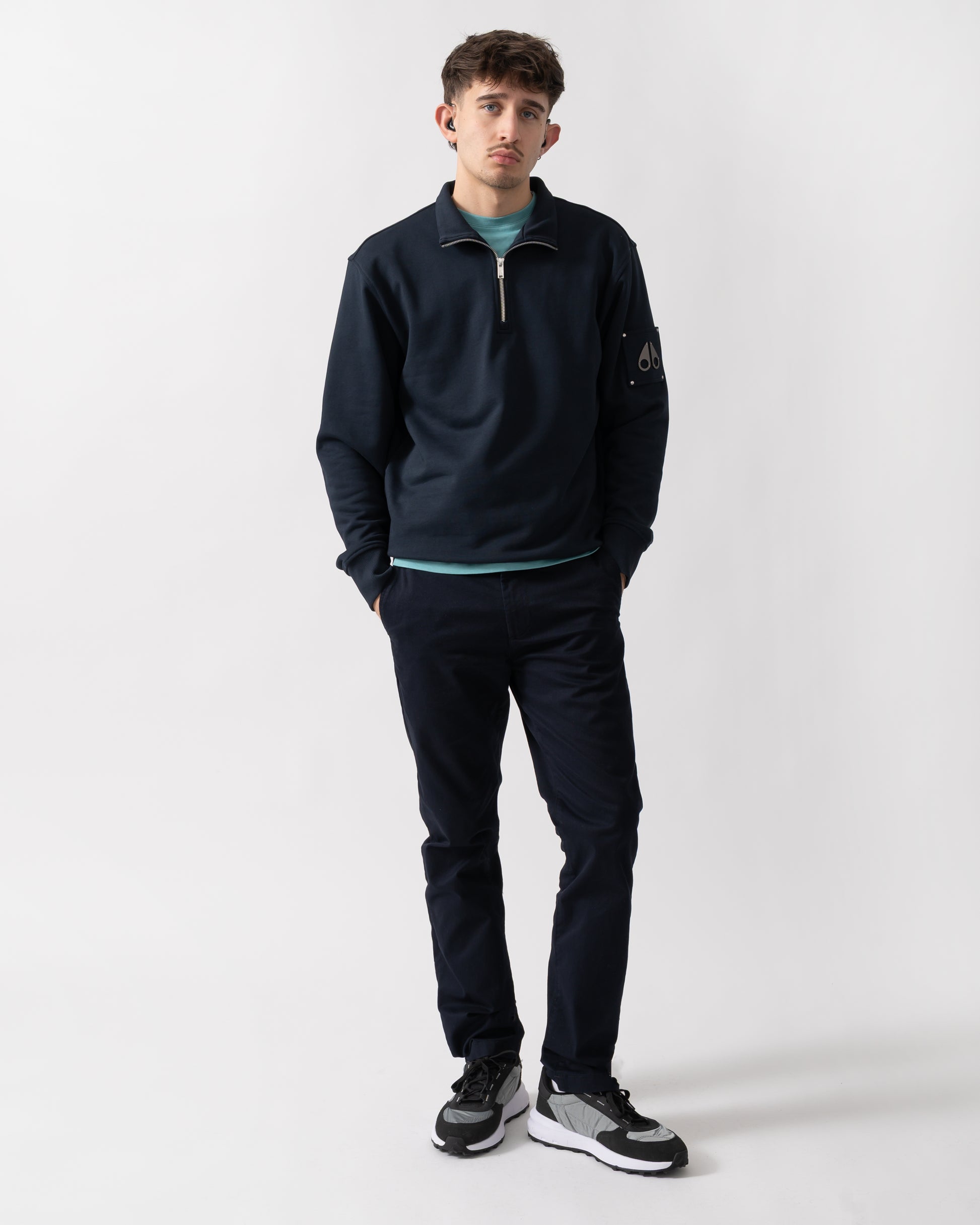 full length shot of a model wearing a Moose Knuckles Hartsfield Mens quarter Zip Sweatshirt in Navy 833