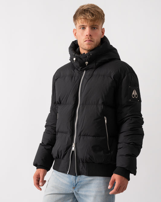 Model wearing a Moose Knuckles Mens Everest Bomber Jacket in Black