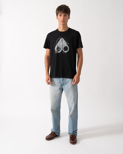 full length shot of a model wearing a Moose Knuckles Mens Icebreak Logo T-Shirt in Black 292