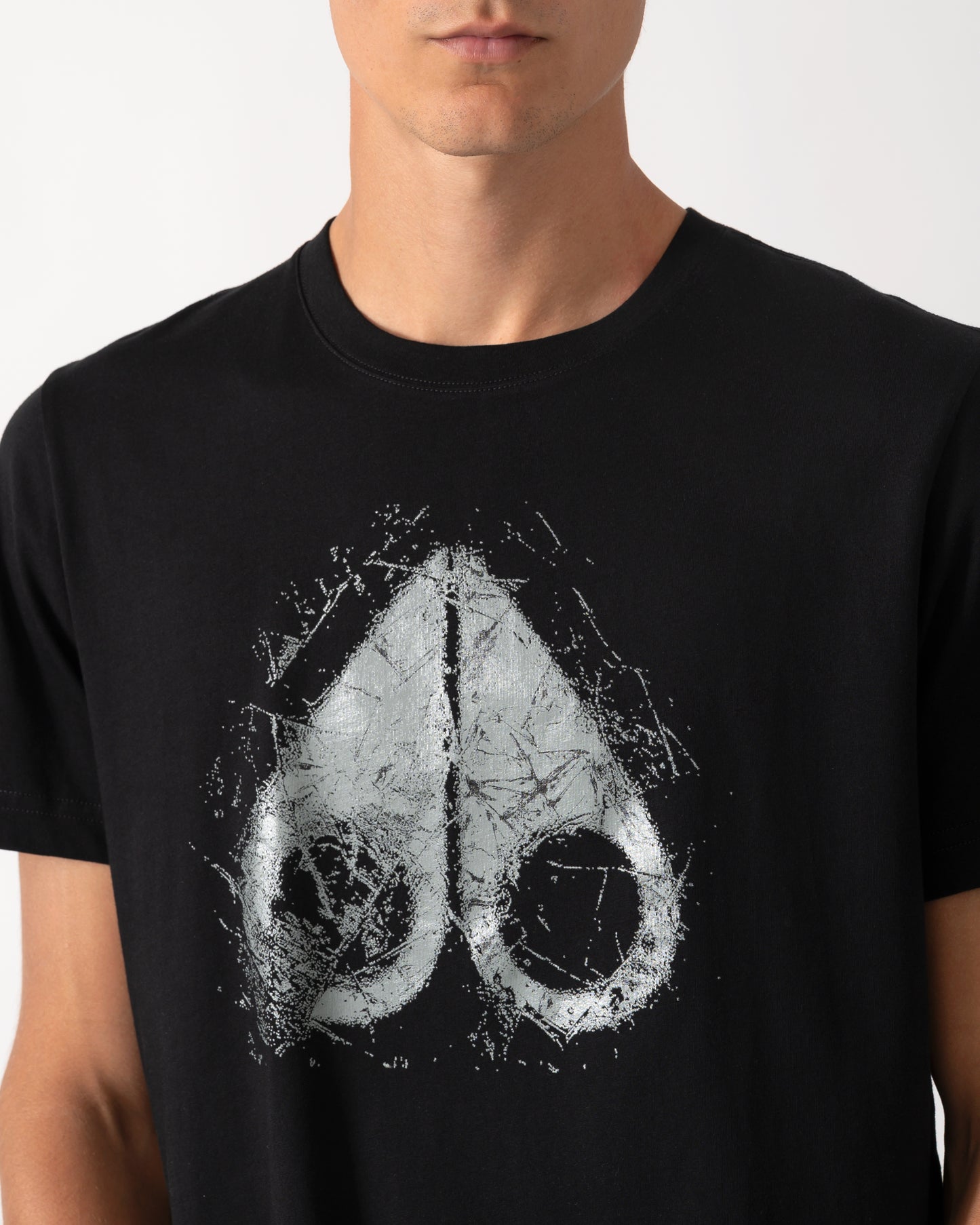 close up of a model wearing a Moose Knuckles Mens Icebreak Logo T-Shirt in Black 292