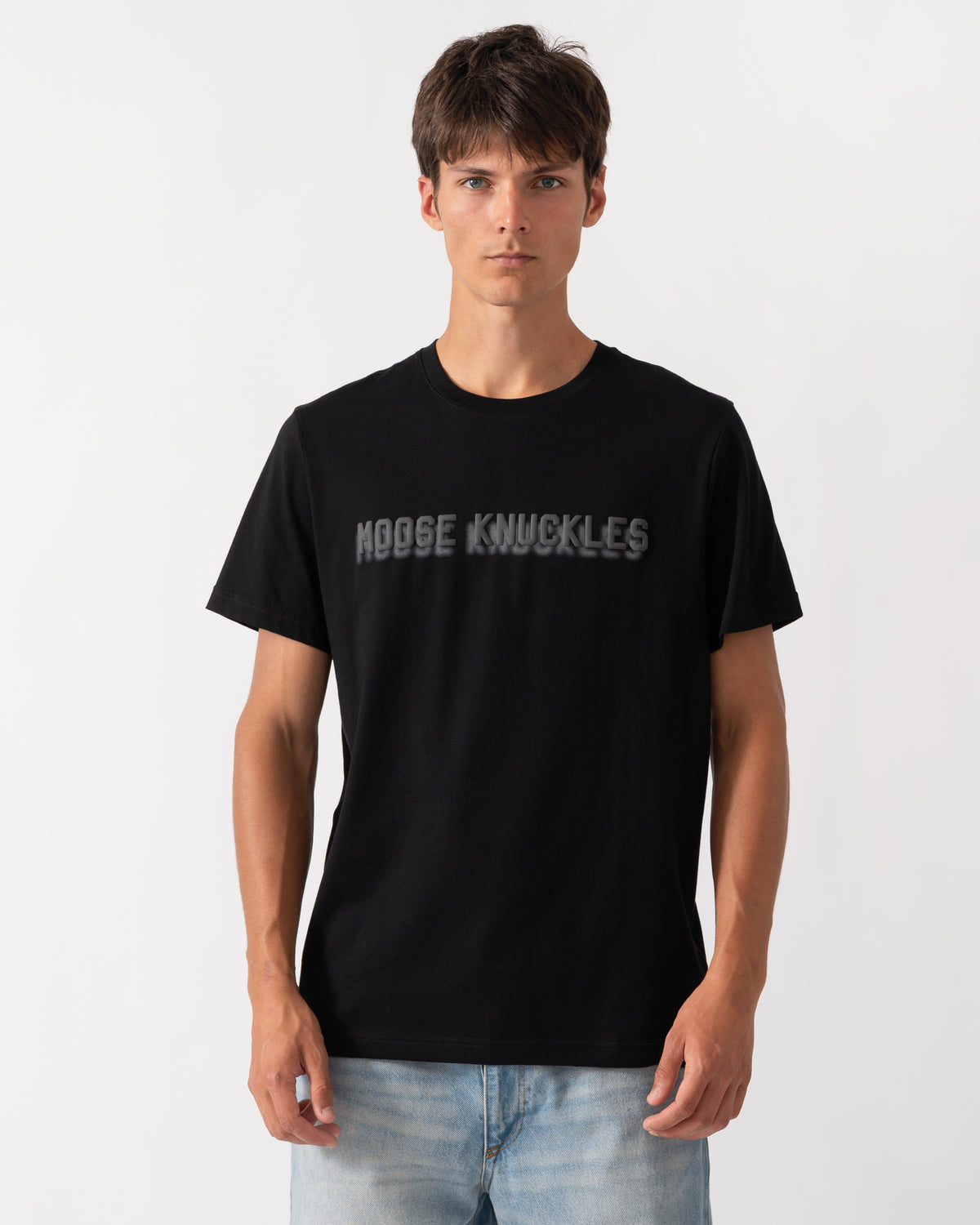 model wearing a Moose Knuckles Mens Shadow Logo T-Shirt in Black 292