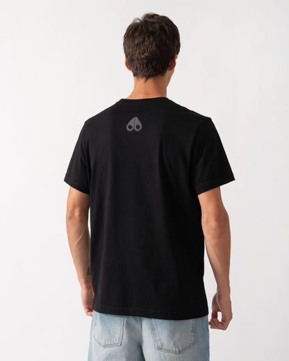 back of a model wearing a Moose Knuckles Mens Shadow Logo T-Shirt in Black 292
