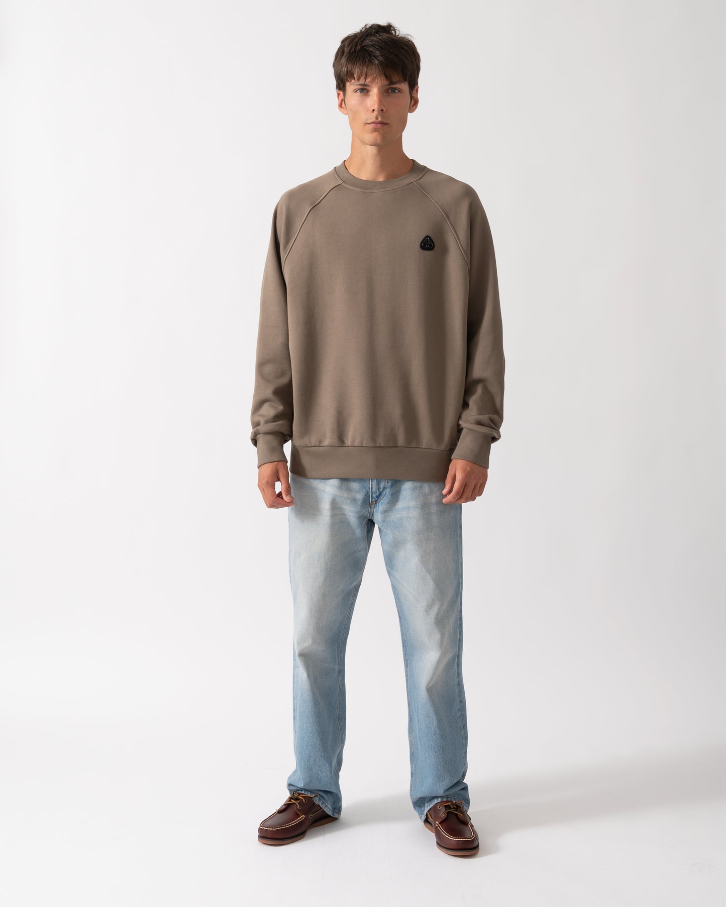 full length shot of a model wearing a Moose Knuckles Mens Yul Crewneck Sweatshirt in Ashen 1968
