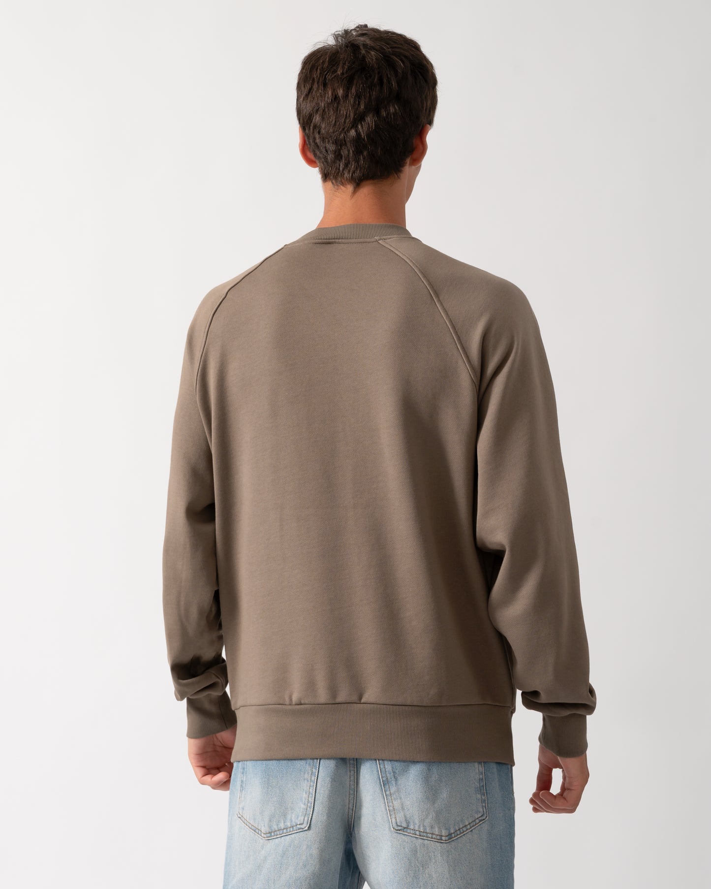 back of a model wearing a Moose Knuckles Mens Yul Crewneck Sweatshirt in Ashen 1968