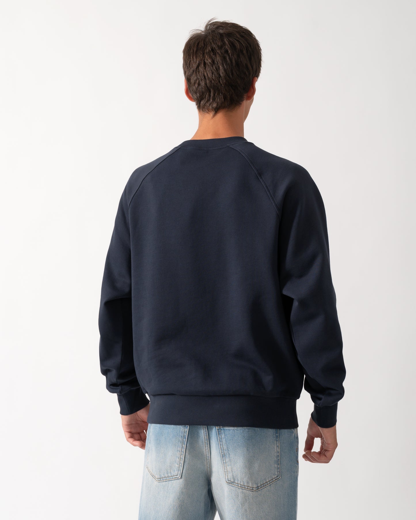 back of a model wearing a Moose Knuckles Mens Yul Crewneck Sweatshirt in Navy 833