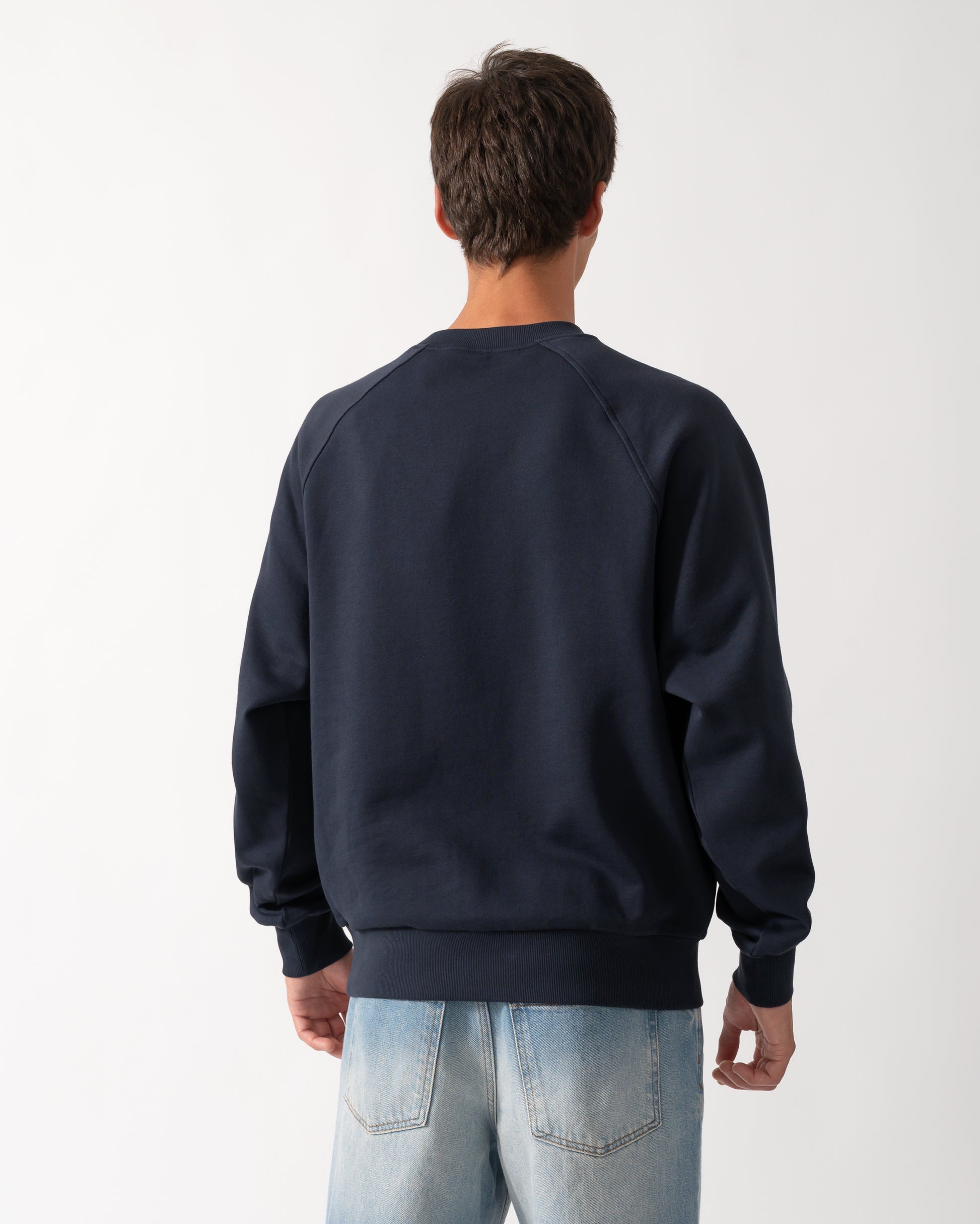 back of a model wearing a Moose Knuckles Mens Yul Crewneck Sweatshirt in Navy 833