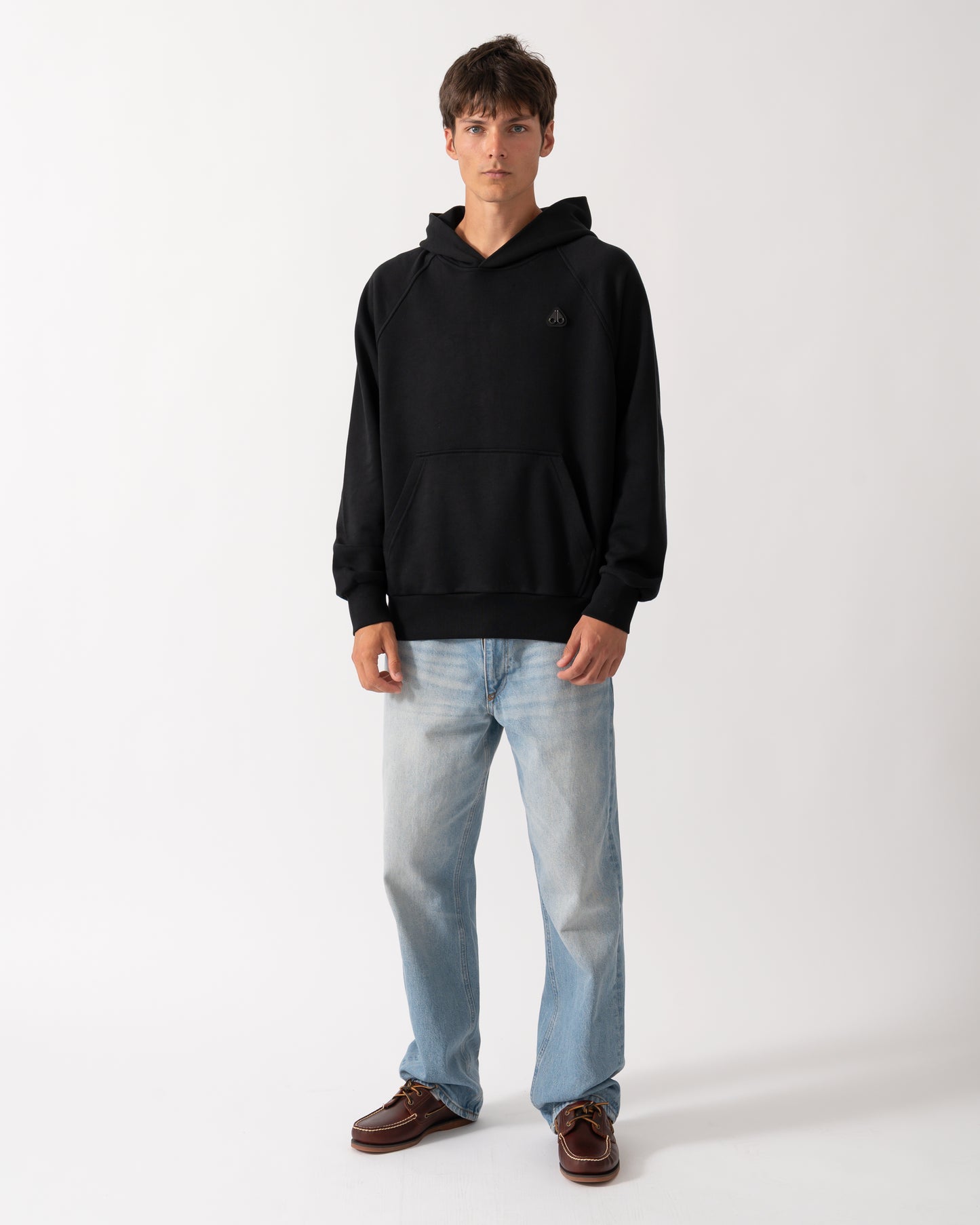 full length of a model wearing a Moose Knuckles Mens Yul Pullover Hoodie in Black 292